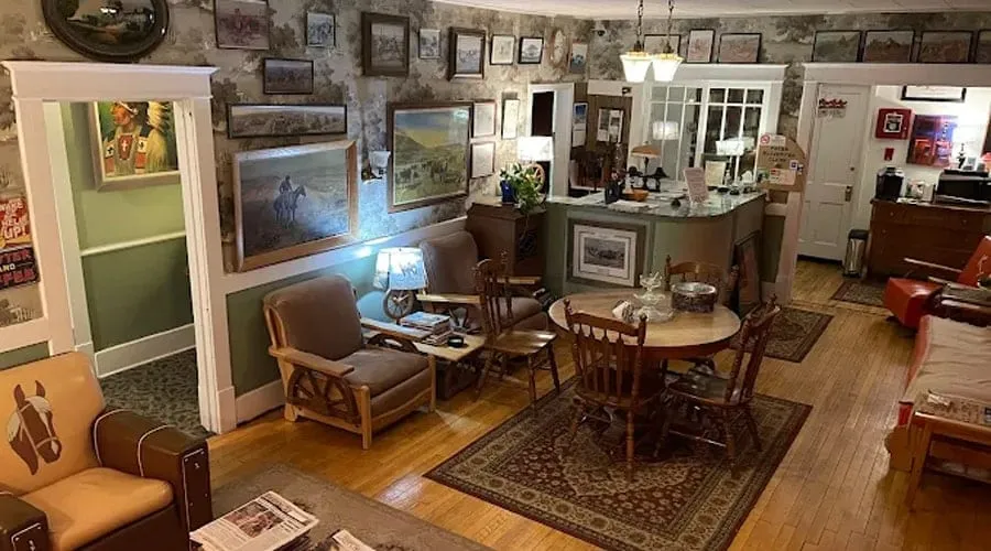 The parlor of the Kempton Hotel, with antique furniture and framed pictures